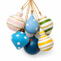 Set of colourful handmade paper mache Christmas baubles with stripes and dots