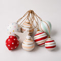 Set of handmade pastel paper mache Christmas baubles with candy stripes and star ornament
