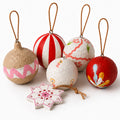 Handmade paper mâché Christmas baubles set of 6 — folk art ornaments on white background
