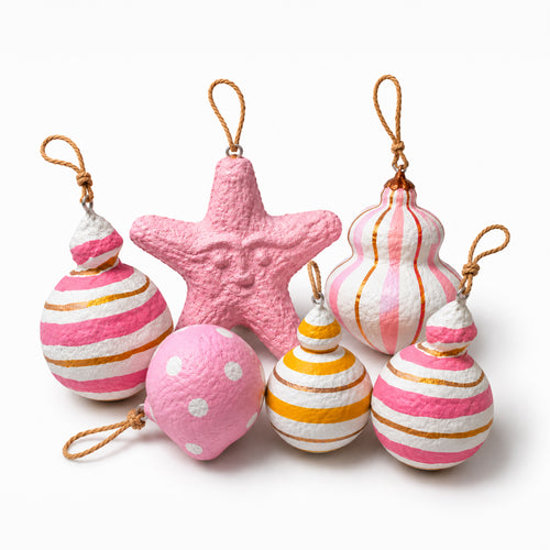 Set of handmade pink paper mache Christmas ornaments with gold detailing and star ornament