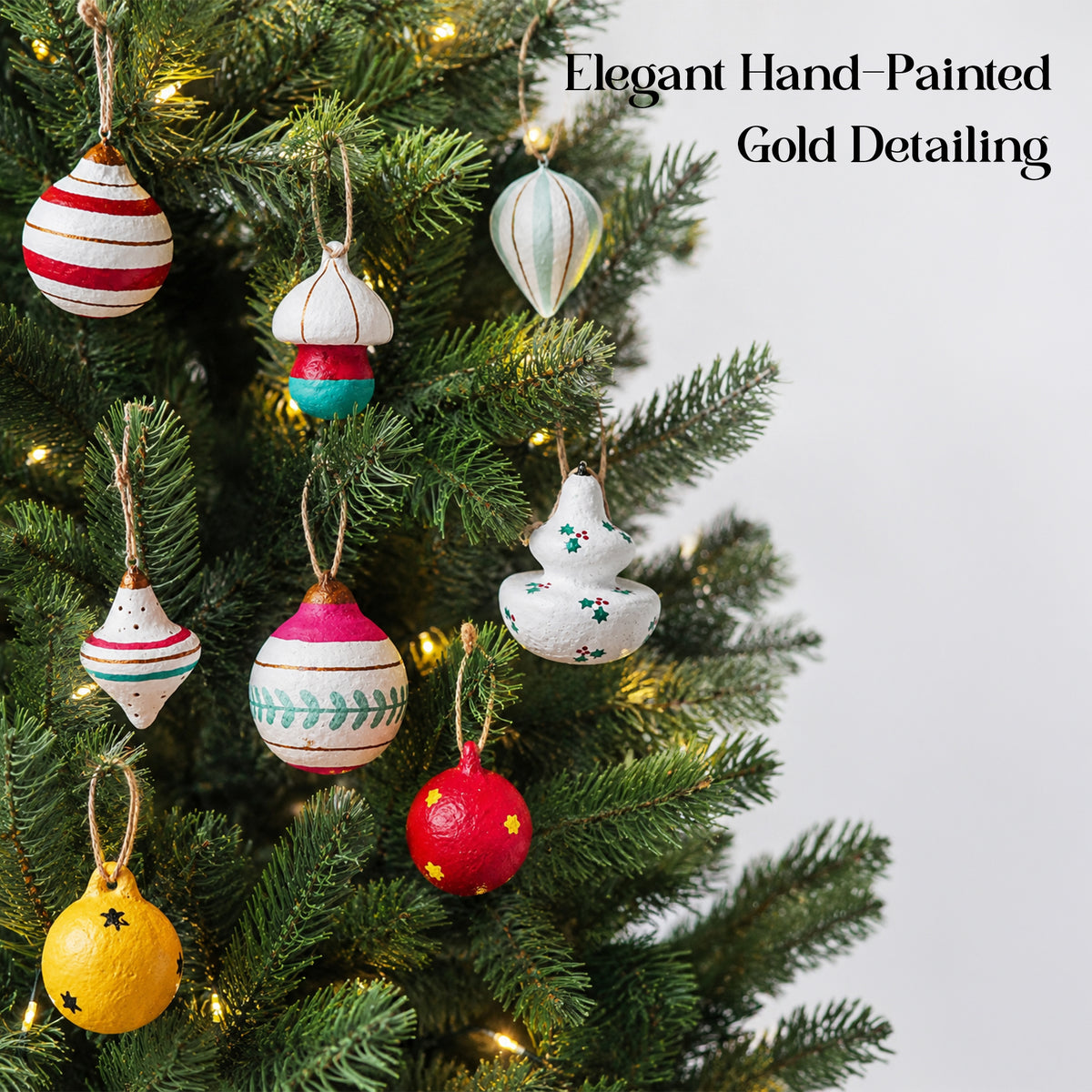 Handmade paper mache Christmas ornaments hanging on a decorated Christmas tree