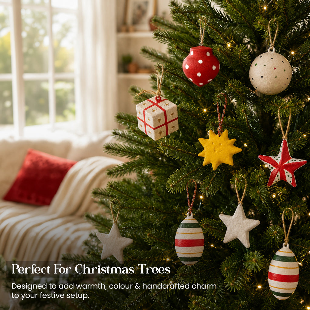 Handmade paper mache Christmas ornament set of 9 hanging on Christmas tree with fairy lights UK living room