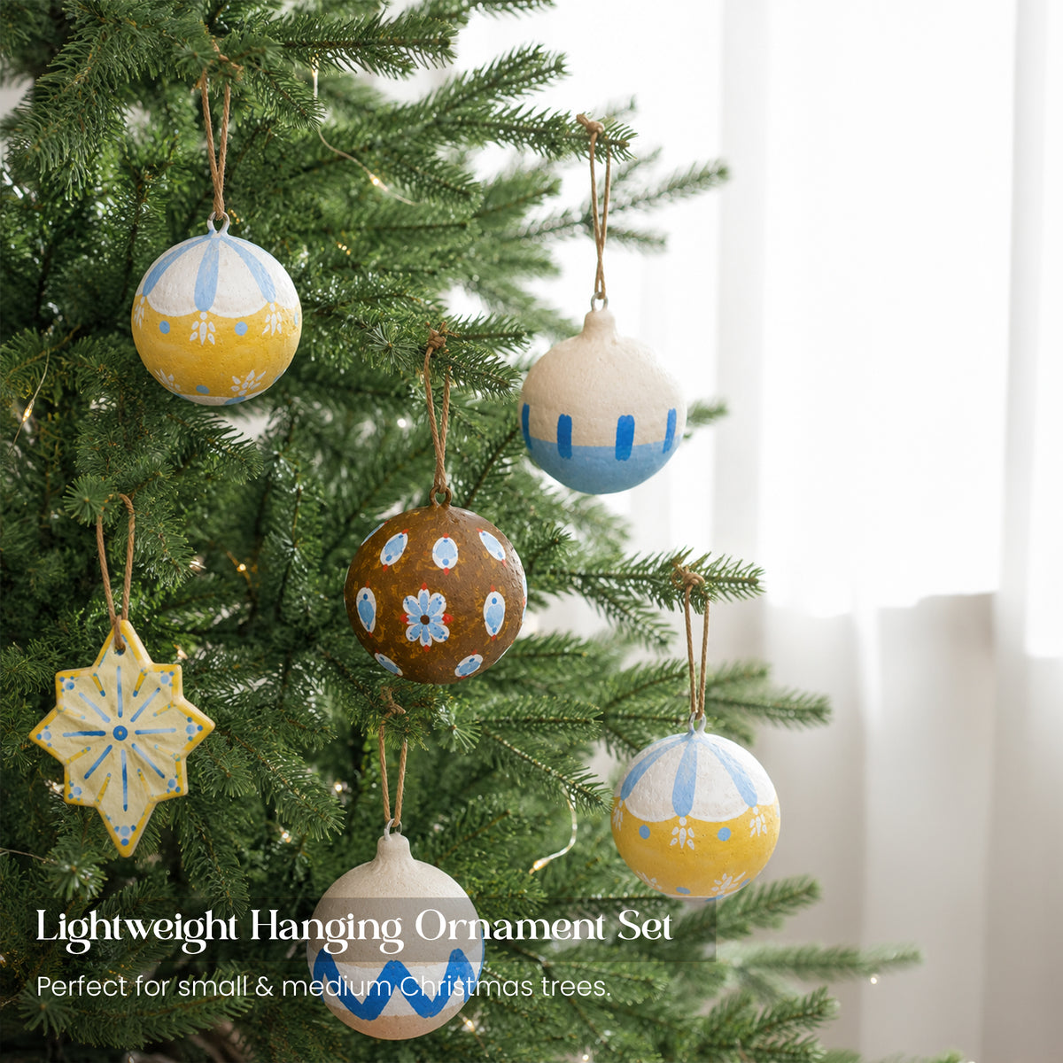 Lightweight handmade paper mache Christmas baubles set hanging on Christmas tree — Scandi folk art designs UK