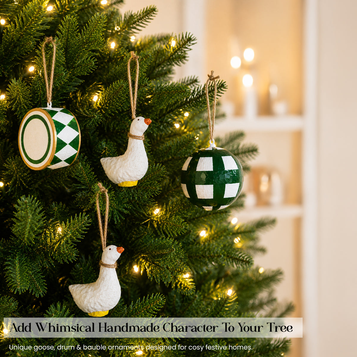 Whimsical handmade white goose figurine and green checkered paper mache bauble hanging on lit Christmas tree