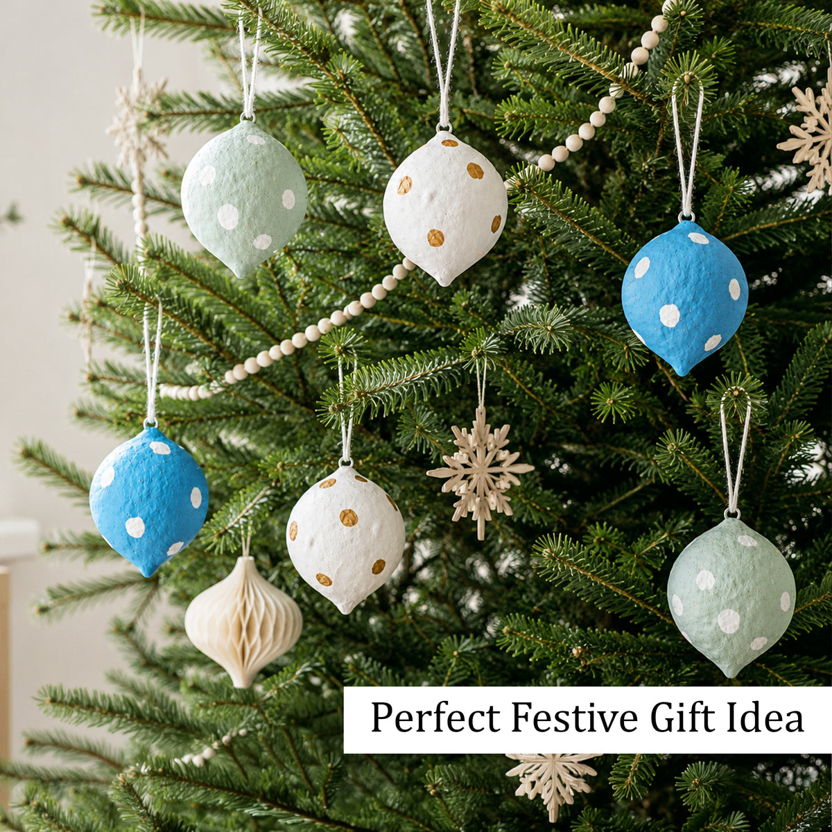 Papier mache Christmas baubles on tree as festive gift idea