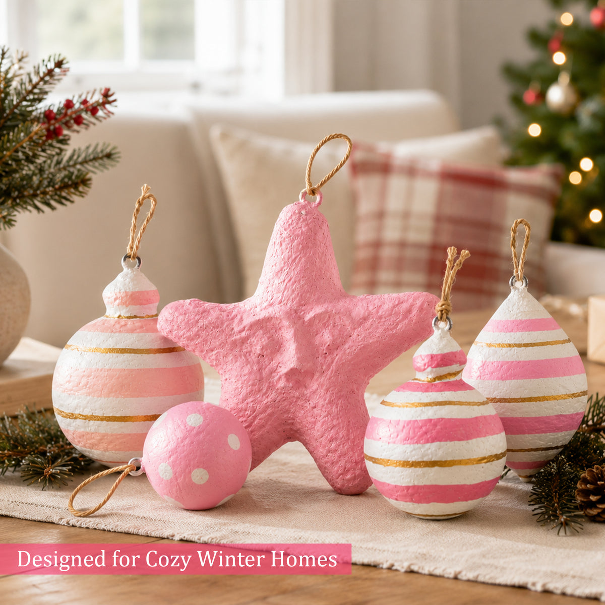 Pink Christmas ornaments styled on a cosy festive table