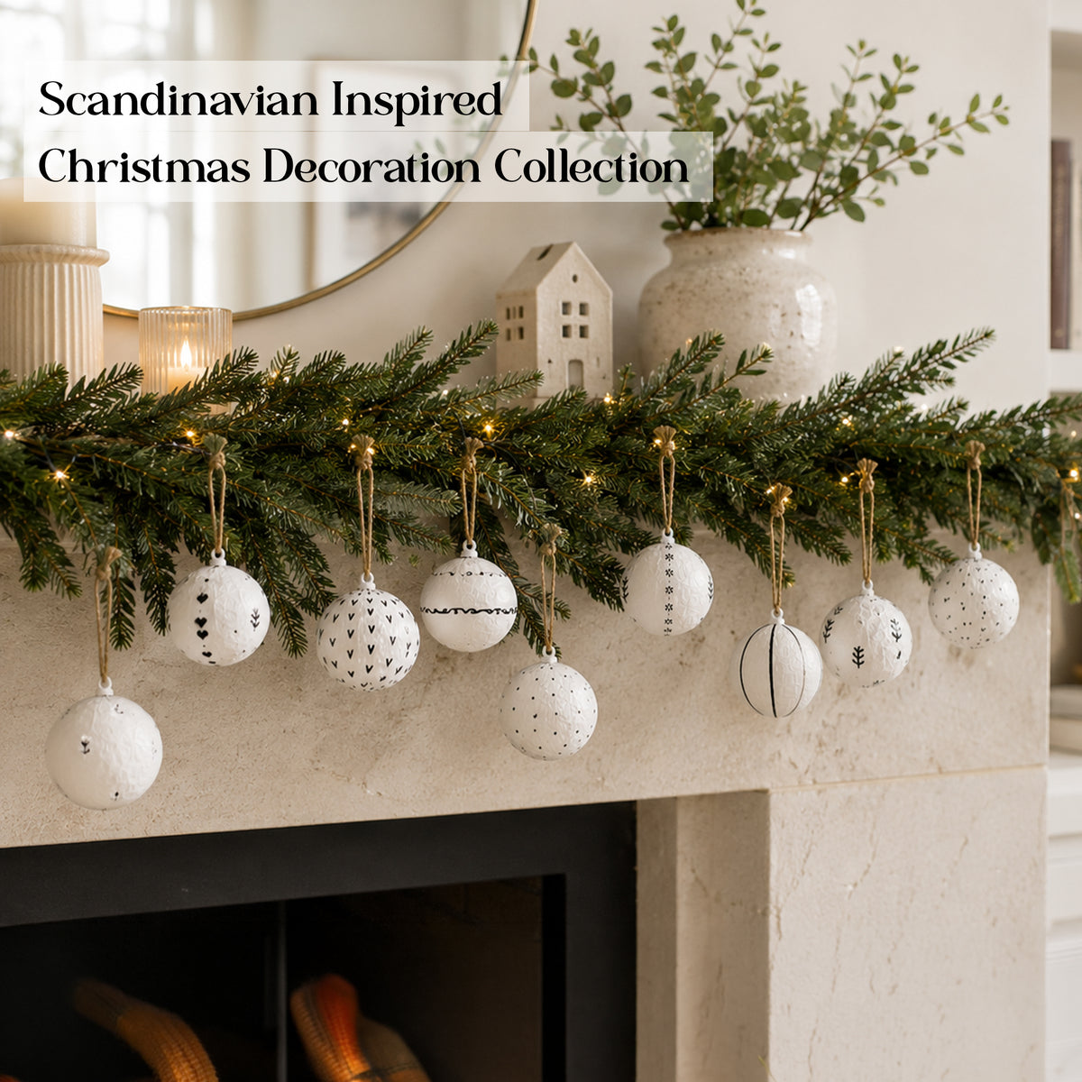 Minimal Nordic Christmas baubles displayed on a mantel with greenery