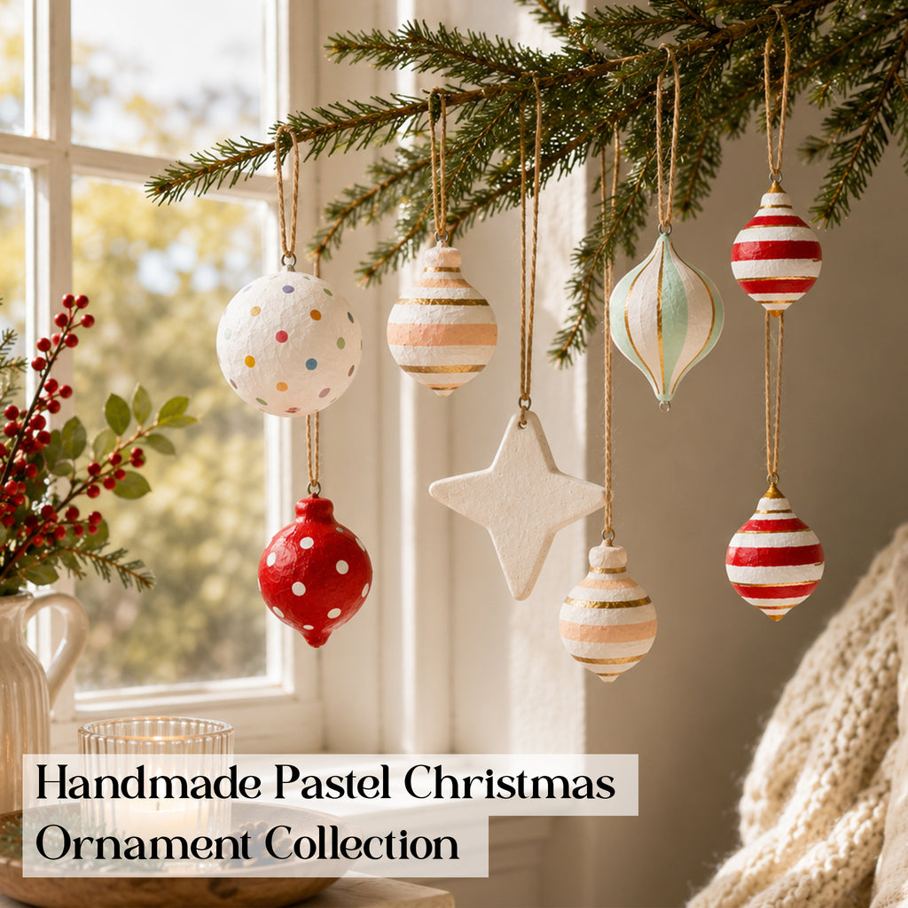 Candy stripe and pastel Christmas baubles hanging near a window