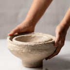 Close up of handmade paper mache bowl texture in natural mud beige finish
