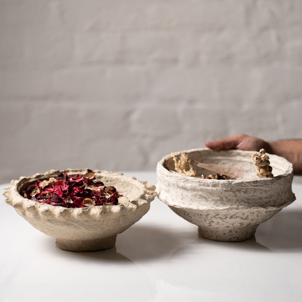 Rustic paper mache bowl filled with dried potpourri in natural beige tones