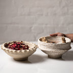 Rustic paper mache bowl filled with dried potpourri in natural beige tones